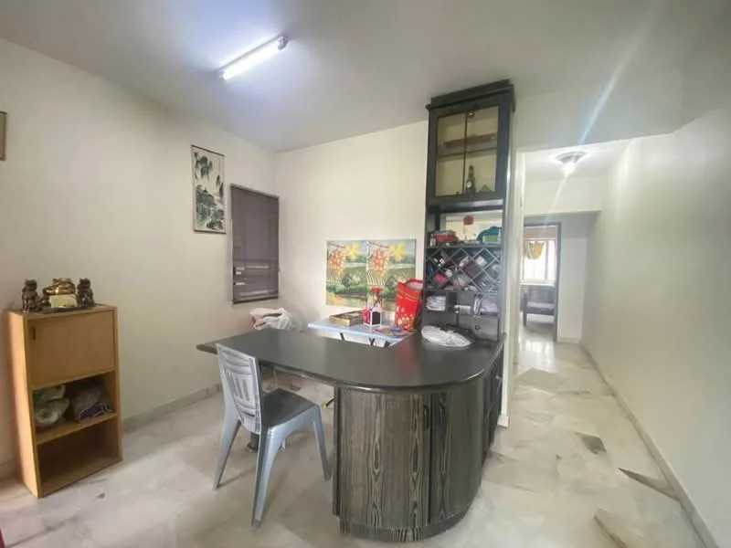 Room features: marble flooring, white painted walls, ceiling light fixture, built-in display cabinet, round dining table, plastic chair, wall-mounted artwork, wine rack, open layout to adjacent room; style: modern.