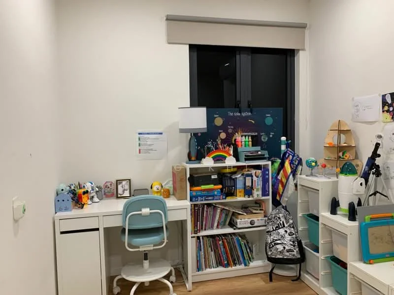 Study features: white painted walls, wooden flooring, desk with white finish, blue ergonomic chair, bookshelf with colorful books, decorative items on desk, lamp on desk, window with black frame, roller blinds, backpack hanging on shelf, decorative globe, colorful wall art; style: modern.