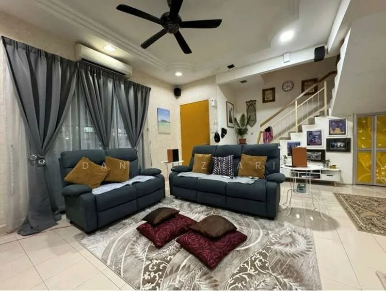 Living features: 2-seater fabric sofa in navy blue, 3-seater fabric sofa in navy blue, decorative throw pillows in brown, area rug with floral pattern, ceiling fan with light, curtains in grey, wall-mounted decor, staircase in background, wall clock, decorative wall art, side table with lamp, potted plant; style: modern.