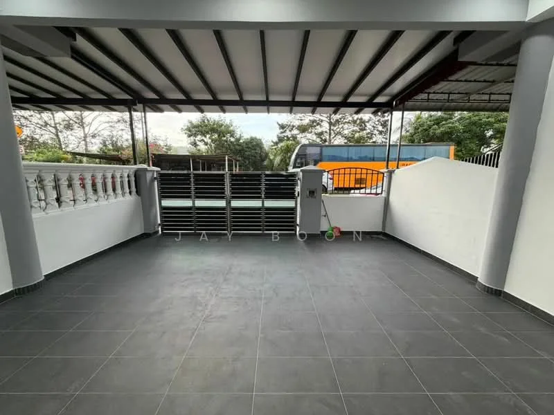Exterior type: car porch; features: covered car porch, grey tiled flooring, white painted walls, metal railing, sliding gate, landscaped greenery in background, concrete wall, roof with metal beams; style: modern.