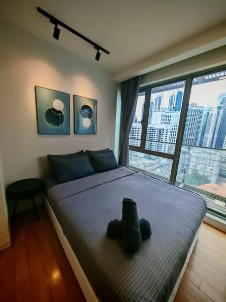 Bedroom features: queen-size bed with grey bedding, two decorative pillows, wall-mounted artwork with circular designs, floor-to-ceiling windows, curtains, wooden flooring, track lighting, side table, city skyline view; style: modern; view: city.