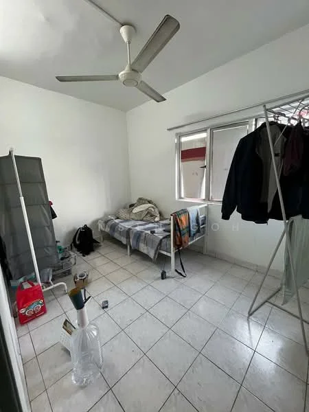 Bedroom features: white painted walls, tile flooring, ceiling fan, single bed, bedding on bed, clothes on bed, clothes rack, window with curtains, laundry basket, plastic storage container.