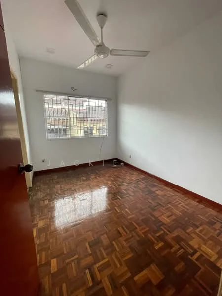 Room features: white painted walls, parquet wood flooring, ceiling fan, window with metal grille, natural light from window.