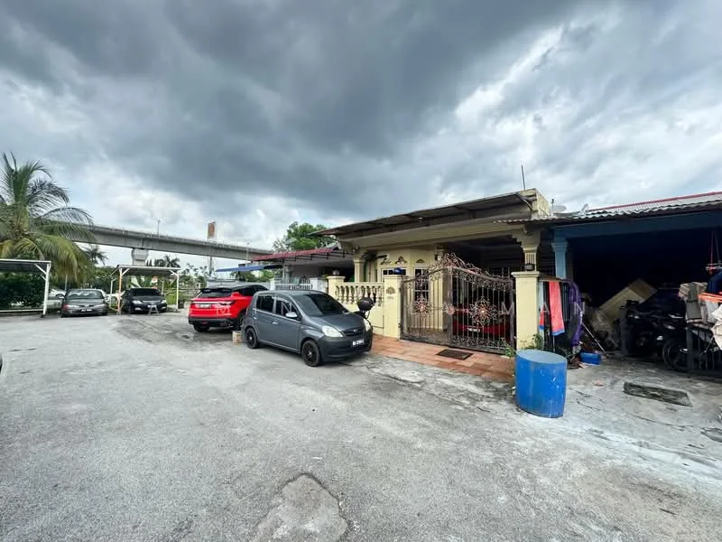 Exterior type: semi-detached house; features: single-storey, painted facade, front gate, driveway with multiple parked cars, paved walkway, overhead structure, surrounded by greenery, outdoor storage area; style: traditional.