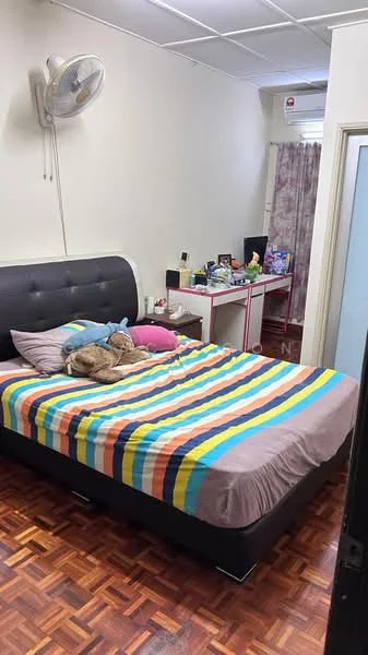 Bedroom features: king-size bed with striped bedding, upholstered headboard, wooden flooring, wall-mounted ceiling fan, desk with computer setup, window with sheer curtains, decorative pillows, stuffed animal on bed, built-in wardrobe with sliding doors, wall-mounted air conditioning unit.