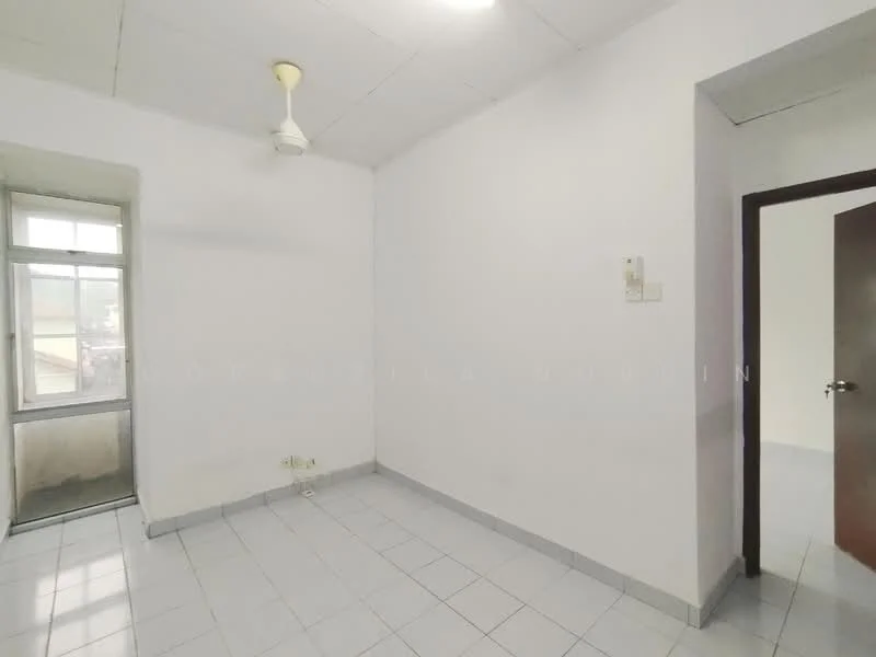 Room features: white painted walls, white ceiling, ceiling fan, tile flooring, single window, door to adjacent room, corner of room with light switch, empty space.