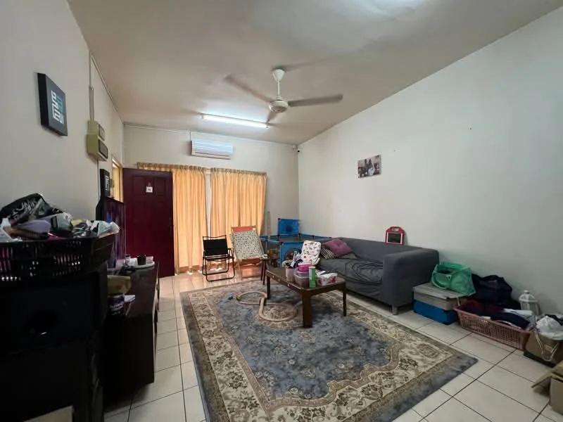 Living features: grey fabric sofa, 3-seater sofa, area rug with floral pattern, ceiling fan, wall-mounted air conditioning unit, light-colored walls, tiled flooring, curtains, coffee table, decorative wall art, stacked chairs, storage baskets.