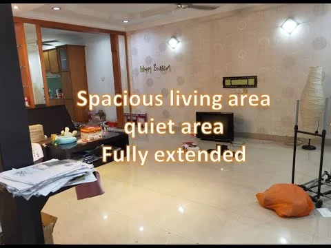 Living features: cream painted walls, glossy tile flooring, recessed downlights, wall-mounted TV, TV console, sofa, coffee table, decorative items on floor, area rug, floor lamp, open layout to kitchen, decorative wall art; style: modern.