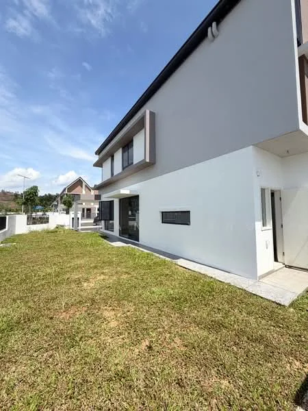 Exterior type: detached bungalow; features: white painted facade, grey accent wall, flat roof, manicured lawn, paved walkway, large windows, single main entrance, surrounded by greenery; style: modern.