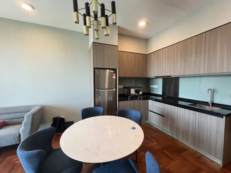 Dining features: round dining table with white marble top, 4 upholstered dining chairs in blue, chandelier with gold accents, wooden flooring, grey fabric sofa, stainless-steel fridge, black countertop, wood cabinetry, sink with faucet, green backsplash; style: modern.