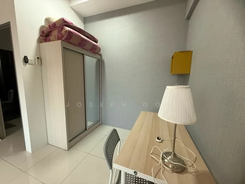 Room features: white walls, grey accent wall, white tiled flooring, built-in wardrobe with sliding doors, desk with light wood finish, grey chair, table lamp with white shade, stack of blankets on top of wardrobe; style: modern.