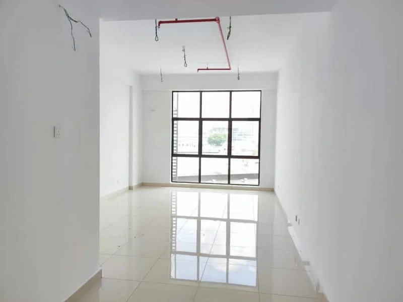 Room features: white painted walls, glossy tile flooring, large floor-to-ceiling windows, exposed ceiling with hanging light fixtures, red exposed piping, natural light from windows, minimalist design, open layout; style: modern; view: city.