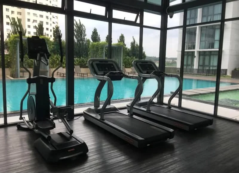 Room features: 3 treadmills, elliptical machine, large windows, wooden flooring, indoor swimming pool view, greenery outside, modern gym equipment, bright lighting; style: modern; view: pool.