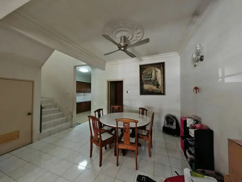 Dining features: round dining table, 6 wooden dining chairs, white tiled flooring, painted walls, ceiling fan with light, framed artwork on wall, wall-mounted sconce, open staircase in background, doorway leading to kitchen, corner cabinet, decorative plant in corner; style: traditional.
