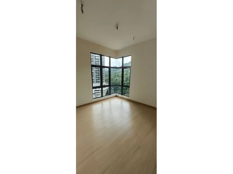 Room features: large floor-to-ceiling windows, wooden flooring, neutral painted walls, corner room layout, natural light from multiple angles, view of greenery, no visible furniture, minimalist design; style: modern; view: garden.