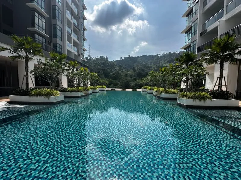 Exterior type: swimming pool deck; features: infinity pool, tiled pool surface with mosaic pattern, surrounded by landscaped gardens, palm trees, greenery along poolside, mountain view in background, sunny weather, deck area with loungers, modern architectural design of surrounding buildings; style: modern.