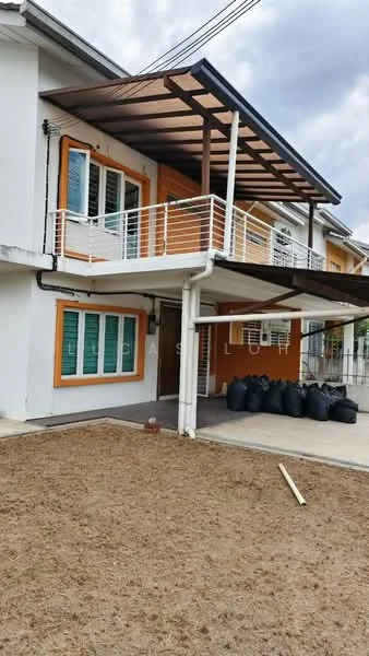 Exterior type: semi-detached house; features: white painted facade, orange accent windows, flat roof with overhang, balcony with railing, manicured lawn area, concrete patio, visible drainage pipes, multiple windows, outdoor space with bags, exterior lighting fixtures; style: modern.