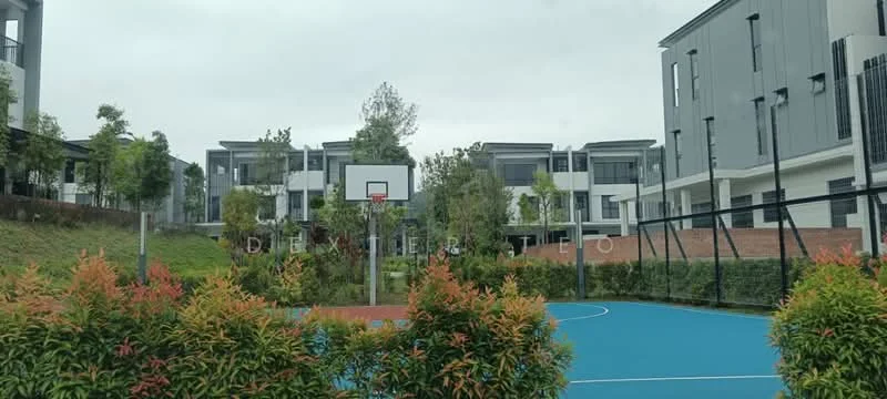 Exterior type: townhouse; features: basketball court, blue synthetic court surface, surrounding greenery, landscaped garden, modern architectural design, two-storey buildings, fenced perimeter, residential units in background; style: modern.