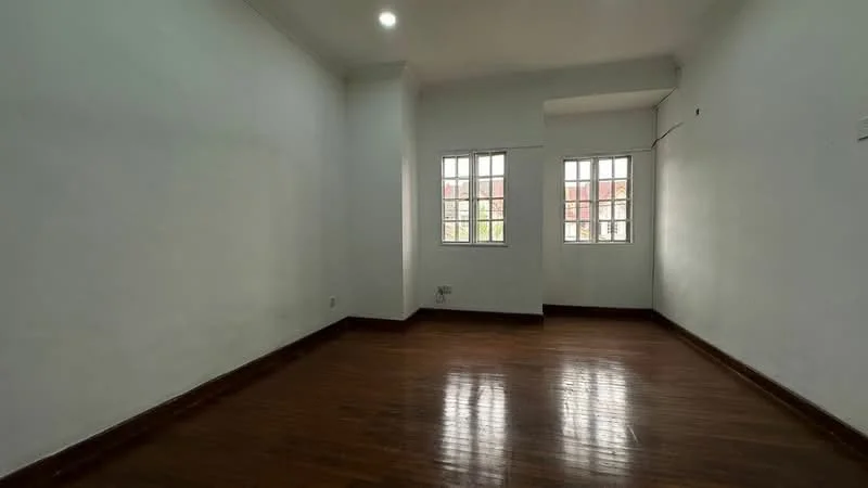 Room features: white painted walls, wooden flooring, two windows, natural light, ceiling light fixture.