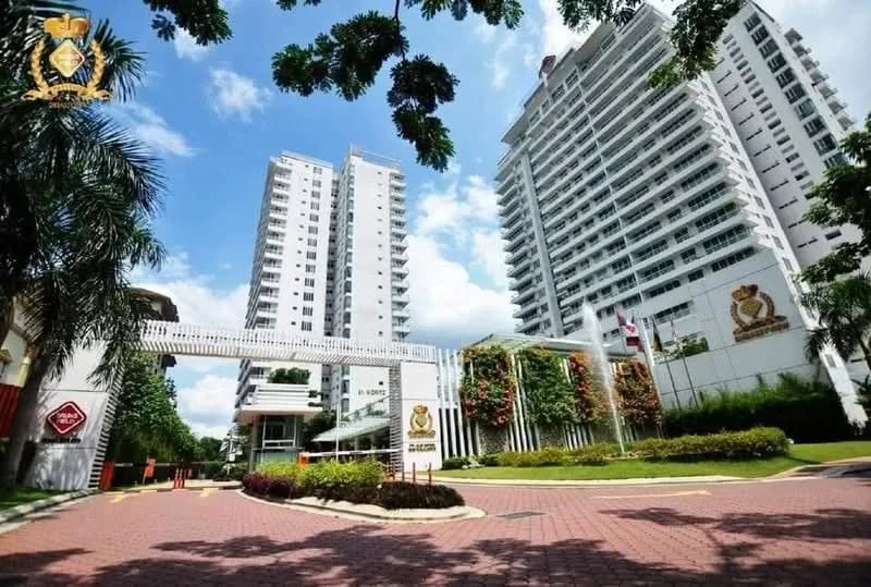 Exterior type: high-rise condominium; features: white painted facade, glass curtain wall, manicured lawn, tropical landscaping, palm trees, driveway with interlocking pavers, double-volume main lobby, feature water wall, security guard house at entrance, gated entry; style: modern.