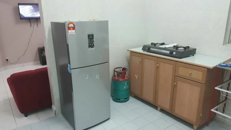 Kitchen features: stainless-steel fridge, gas stove with 4 burners, wood cabinetry, white countertop, green gas cylinder, white tiled walls, white tiled flooring, television on wall.