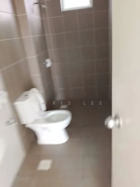 Bathroom features: white toilet, shower head, tile flooring, brown tiled walls, window for natural light, sink with faucet, bath mat, toilet paper holder.
