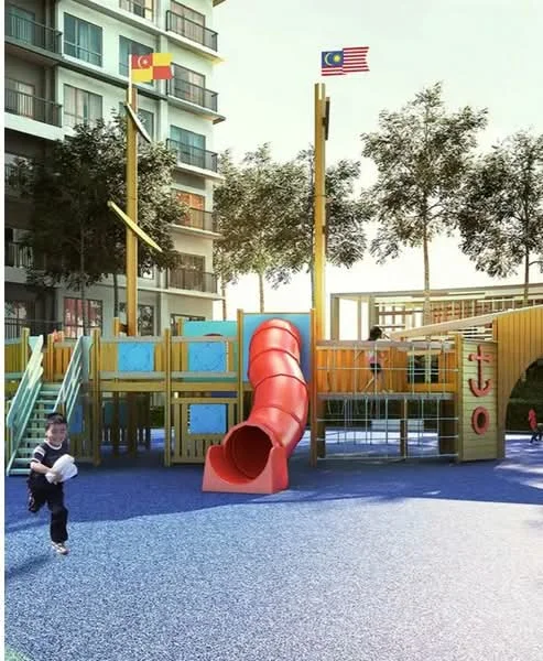 Exterior type: children's playground; features: red slide, climbing structure, playground equipment, rubberized flooring, two flags (Malaysia and another), surrounding trees, open space, blue playground surface; style: modern.