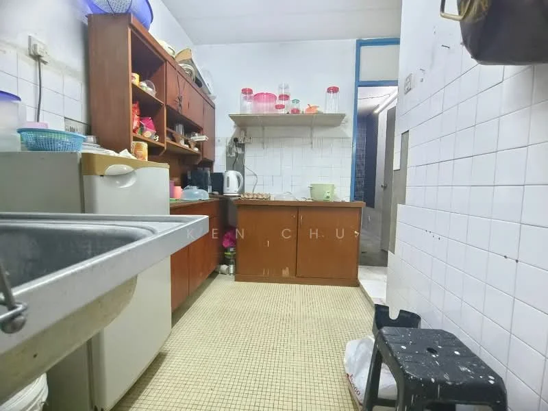 Kitchen features: single-bowl stainless-steel sink, chrome pull-down faucet, wood cabinetry, open shelving, white tiled walls, vinyl flooring, countertop with storage underneath, refrigerator, stool, kitchen utensils on shelves, light fixture on ceiling.