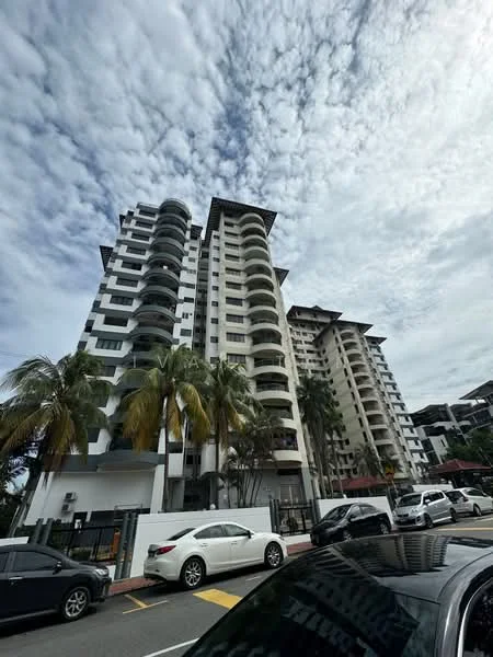 Exterior type: mid-rise condominium; features: white painted facade, balconies with curved edges, multiple storeys, palm trees in front, parking area visible, cloudy sky, surrounded by greenery; style: modern.