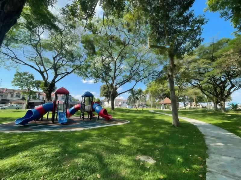Exterior type: landscape garden; features: children's playground with slides and climbing structures, manicured lawn, mature trees providing shade, paved walkway, open green space, surrounding residential houses; style: modern.