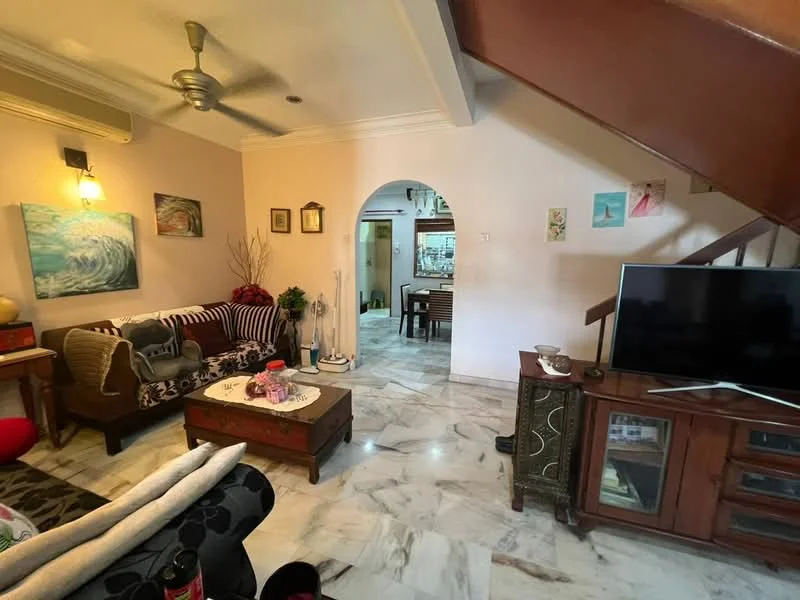 Living features: 3-seater fabric sofa in black, 2-seater fabric sofa in beige, coffee table with decorative items, TV console with wall-mounted TV, marble flooring, ceiling fan, wall-mounted artwork, decorative plants, wooden side table, light fixture on wall; style: traditional. Room features: arched doorway, dining area visible in background, staircase leading to upper floor, painted walls in beige.