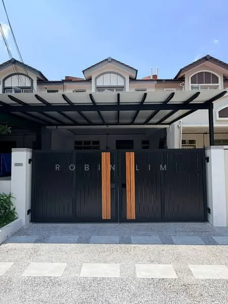 Exterior type: linked terrace house; features: black painted gate with wooden accents, covered car porch, white painted facade, red tiled roof, mature greenery along the fence, stone-paved driveway, multiple storey structure; style: modern.