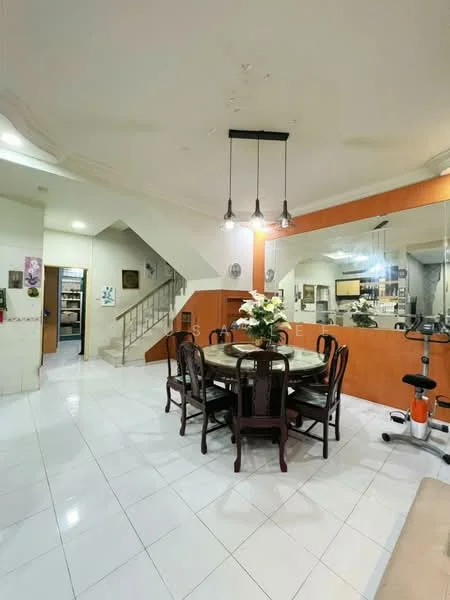 Dining features: round dining table, upholstered dining chairs, white tiled flooring, recessed downlights, decorative wall mirror, wall-mounted artwork, staircase in background, open layout to living area; style: modern. Room features: white painted walls, orange accent wall, glass display cabinet, exercise equipment.