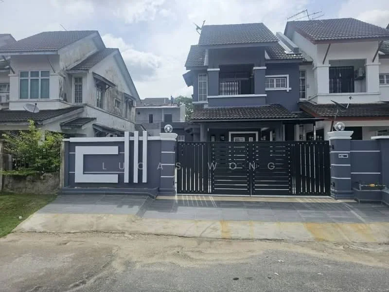 Exterior type: semi-detached house; features: grey painted facade, white trim, gated entrance, black metal gate, paved driveway, manicured lawn, two-storey structure, roof with tiles, balconies on upper floor, outdoor lighting fixtures, surrounding greenery; style: modern.