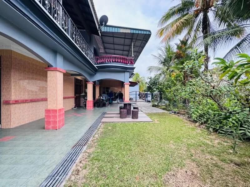 Exterior type: detached bungalow; features: manicured lawn, tropical landscaping, paved walkway, covered patio area, balcony with decorative railing, outdoor seating area, surrounded by palm trees, garden area with shrubs; style: tropical-modern.