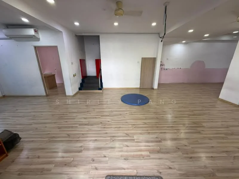Room features: laminate wood flooring, white painted walls, recessed downlights, 1 wall-mounted split AC, staircase leading to upper level, open space layout, blue circular mat, doorway leading to another room, doorway leading to bathroom area; style: modern.