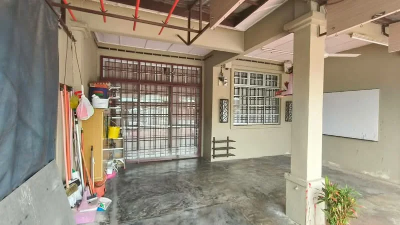 Room features: concrete flooring, grey painted walls, large windows with metal grills, wooden door with glass panels, whiteboard mounted on wall, shelving unit with storage bins, exposed ceiling beams, open layout; style: modern.