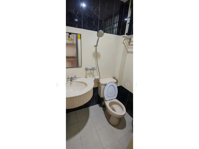 Bathroom features: single-sink vanity with circular basin, chrome basin mixer faucet, framed mirror, one-piece toilet, handheld shower, wall-mounted showerhead, tile flooring, black tiled walls, cream painted walls, built-in shelf, light fixture; style: modern.