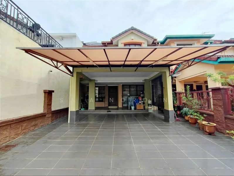 Exterior type: linked terrace house; features: car porch with awning, grey tiled flooring, exposed brick wall, green painted columns, manicured garden area, potted plants, two-storey structure, gated entry, surrounded by residential buildings; style: modern.