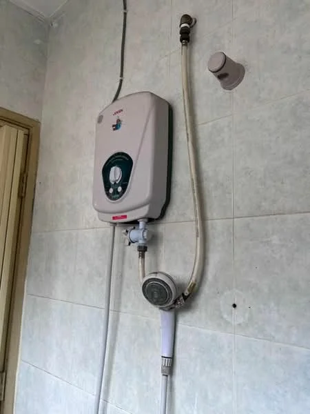 Bathroom features: water heater, showerhead, white tiled walls, chrome plumbing fixtures.