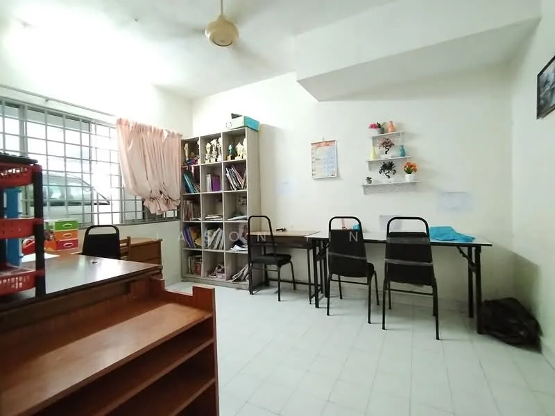 Study features: white painted walls, tile flooring, ceiling fan, large window with metal grille, wooden bookshelf with open shelving, black metal study tables, black plastic chairs, decorative wall shelves, curtains, storage cabinet; style: minimalist.