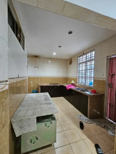 Kitchen features: ceramic tile flooring, white tiled walls, brown cabinetry, countertop with patterned surface, single-bowl stainless-steel sink, window with metal grille, door with metal frame, overhead lighting, open layout, kitchen table, cleaning supplies visible.