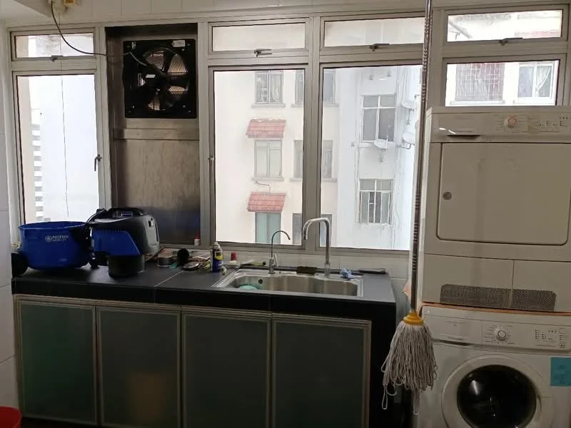 Laundry features: black countertop, single-bowl stainless-steel sink, chrome faucet, washing machine, dryer, window with city view, exhaust fan, cabinets below countertop, cleaning supplies on countertop, mop hanging, white tiled walls; style: modern; view: city.