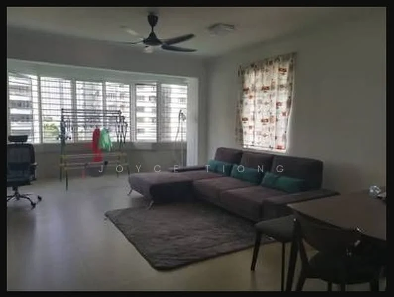 Living features: 3-seater fabric sofa in dark grey, L-shape sectional sofa, area rug, ceiling fan, large windows with horizontal slats, curtains with floral pattern, dining table for 4, wooden dining chairs, wall-mounted TV, office chair, clothes drying rack; style: modern; view: garden.