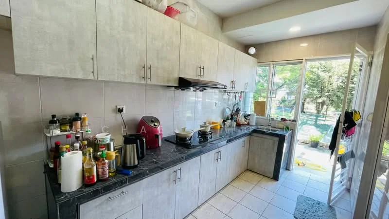 Kitchen features: grey laminate cabinetry, black granite countertop, stainless-steel sink, chrome pull-down faucet, built-in stove, microwave, toaster, kettle, various cooking oils and condiments on countertop, tile flooring, window with view to outdoor space, door leading to outdoor area; style: modern; view: garden.