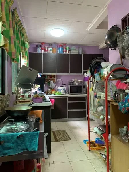 Kitchen features: purple painted walls, white ceiling, tile flooring, wood cabinetry in dark brown, stainless-steel gas stove, microwave, kitchen sink, countertop with utensils, open shelving with dishes, refrigerator, window with green checkered curtains, kitchen mat, dish rack, various kitchen appliances.