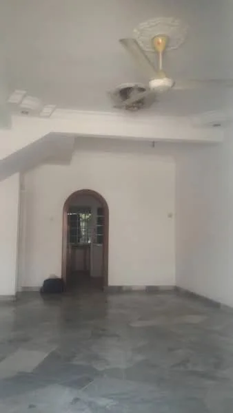 Room features: white painted walls, marble flooring, 5-blade ceiling fan with light, arched doorway, window with grille, high ceiling, corner staircase, natural light from window.