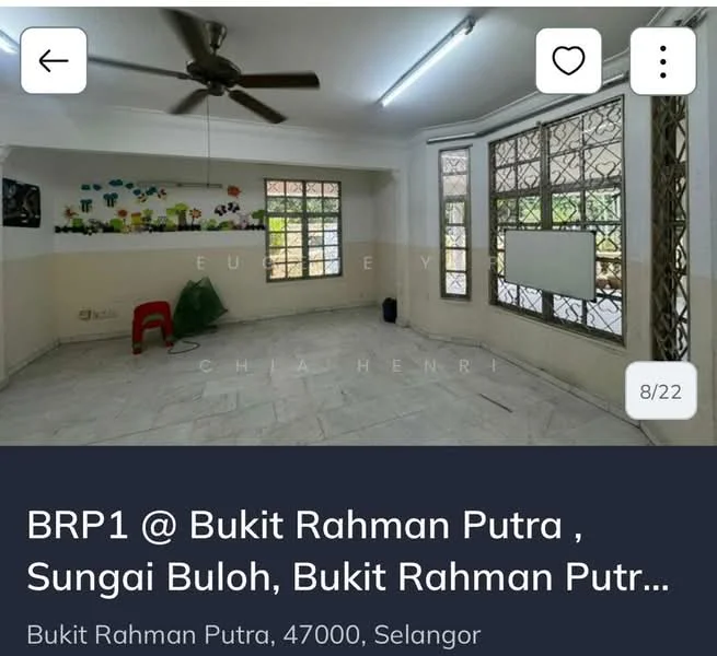 Room features: white painted walls, grey tiled flooring, large windows with metal grilles, natural light from windows, decorative wall decals, one red plastic chair, corner with potential for furniture placement, high ceiling.