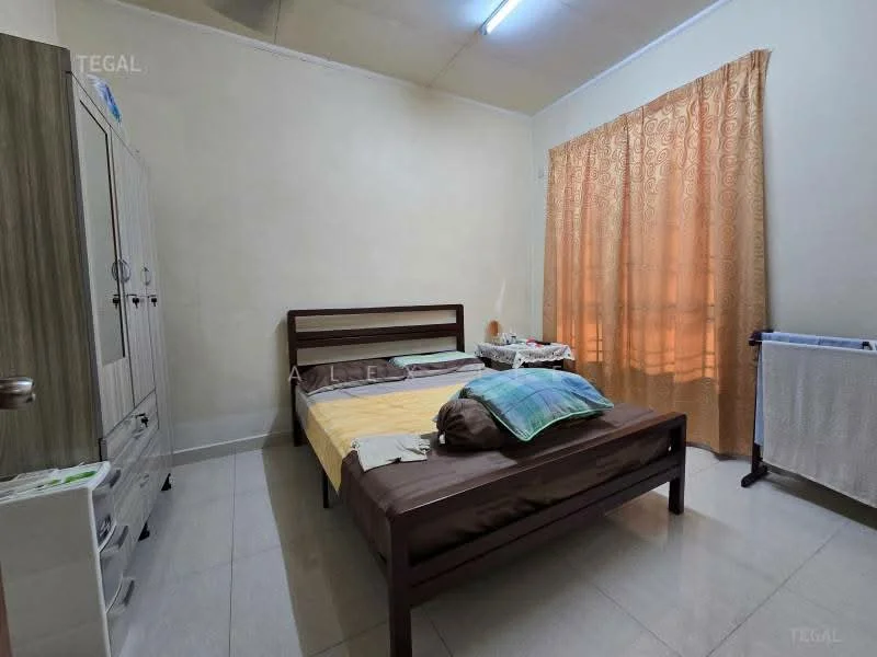 Bedroom features: queen-size bed, wood bed frame, yellow bedspread, two pillows, curtains in light orange, cream painted walls, tile flooring, built-in wardrobe, small bedside table, wall-mounted light fixture, window with natural light.