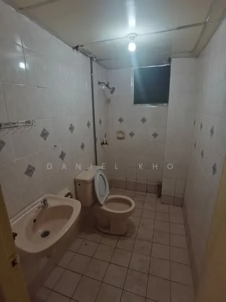 Bathroom features: white tiled walls, white ceramic floor tiles, single-sink vanity, toilet, shower with handheld showerhead, window for natural light, ceiling light fixture.
